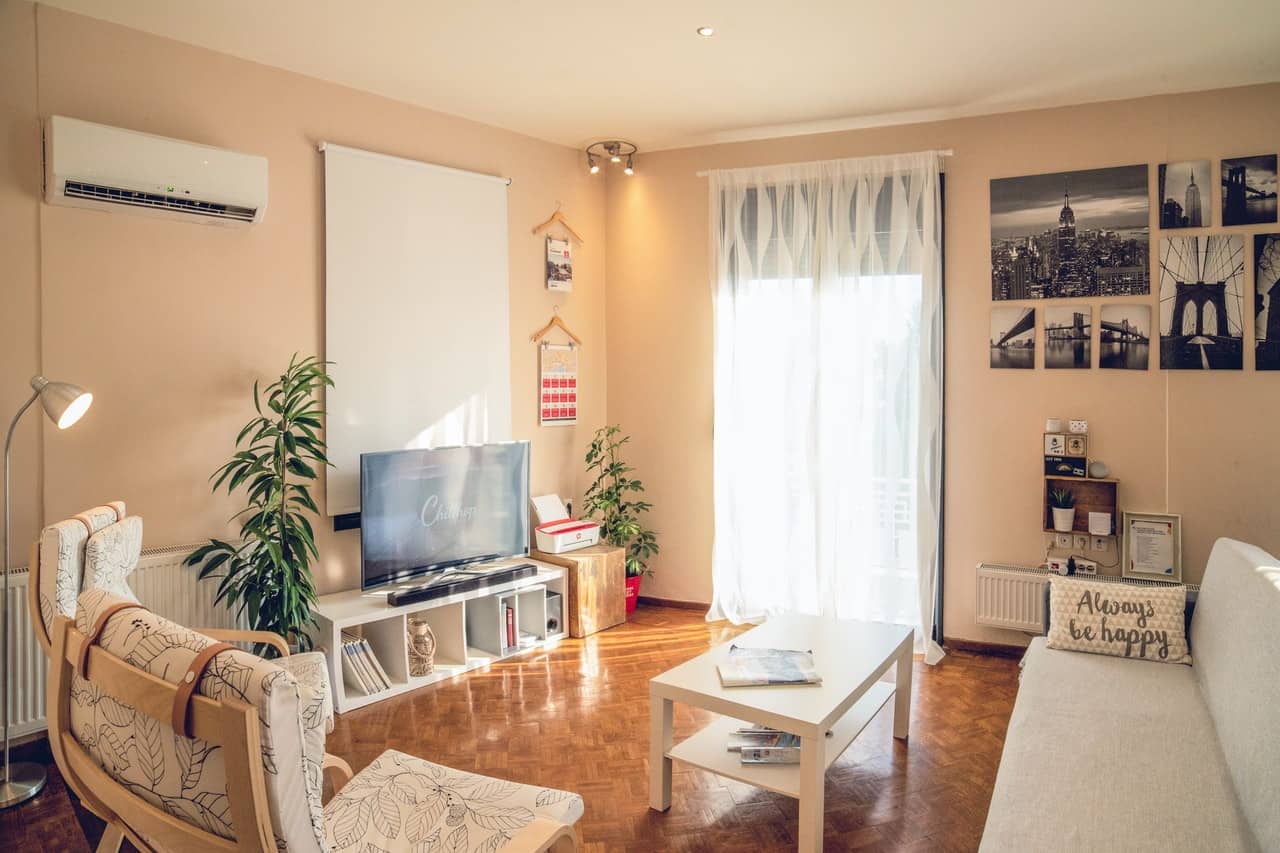 A sunny apartment with light walls and comfy furniture