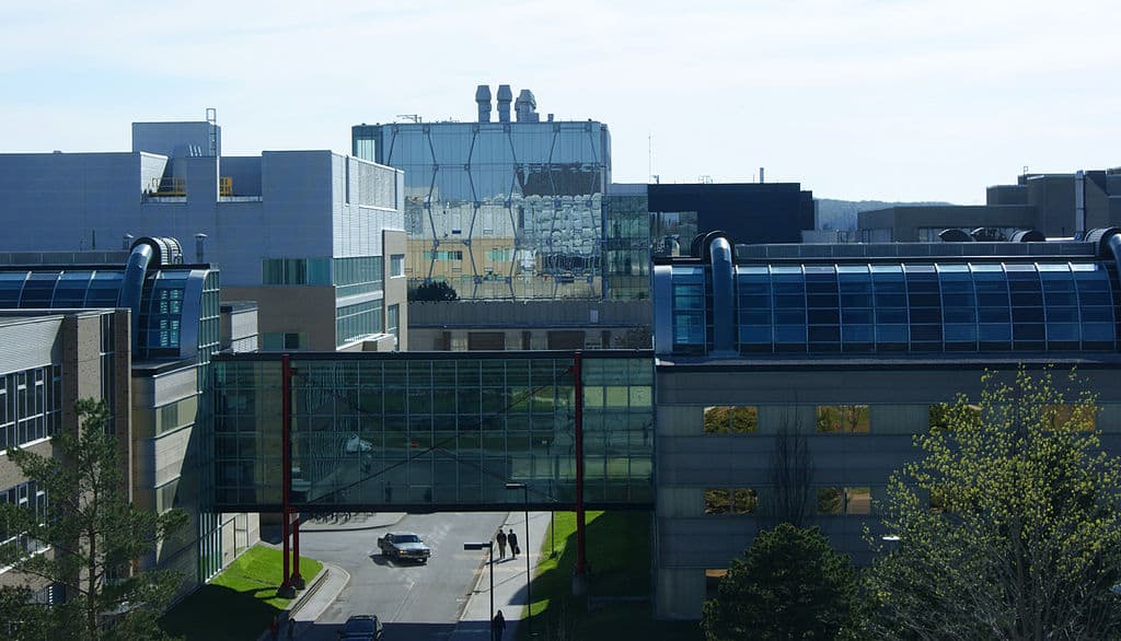 A landscape view of modern university buildings at the University of Waterloo (lots of steel and glass)