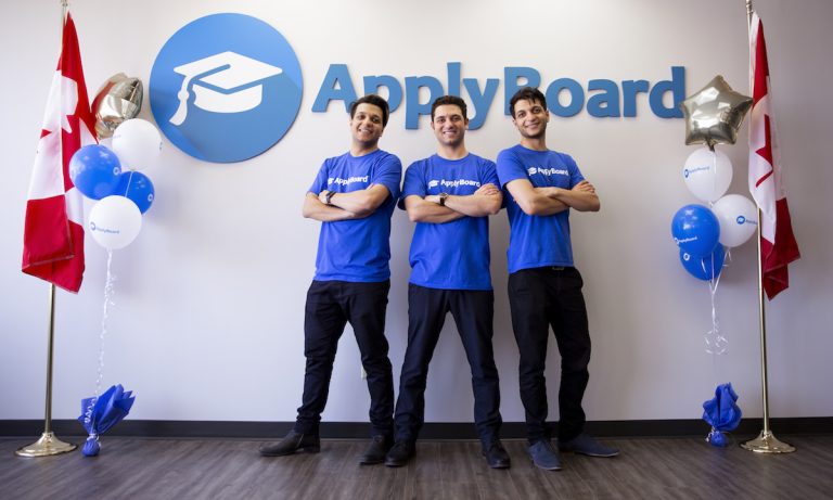 ApplyBoard's CEO, CMO, and COO in front of ApplyBoard's sign