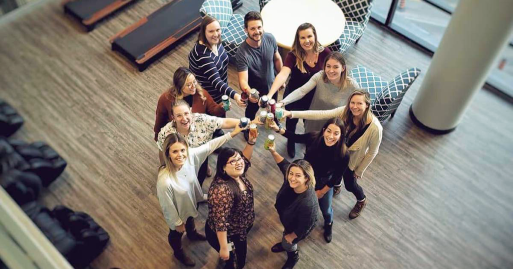 Members of Beer Club "cheers-ing" in the Kitchener ApplyBoard office