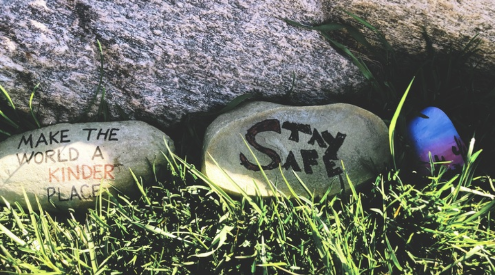 Rocks with "Make the world a kinder place" and "Stay safe" written on them