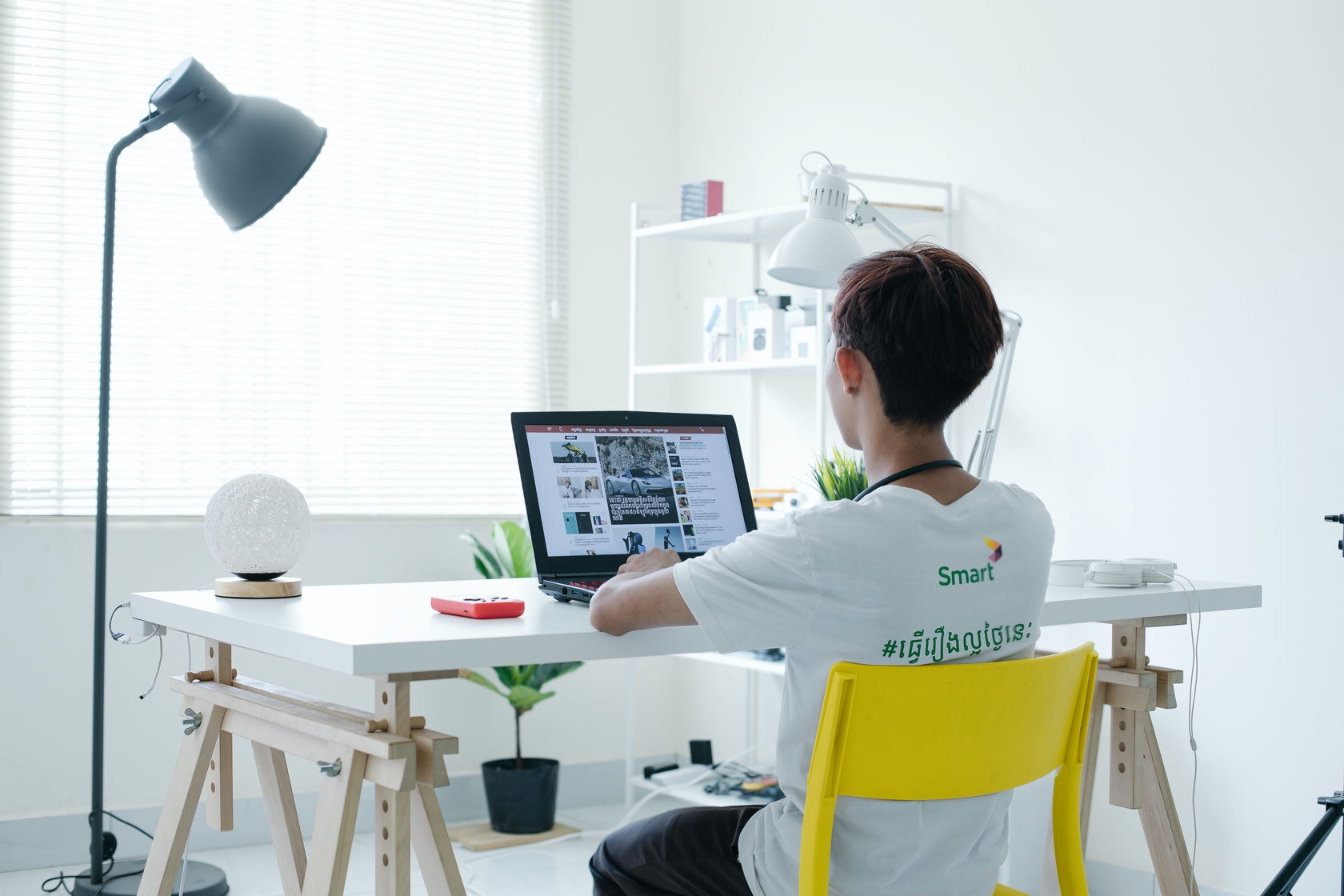 Person working on laptop at table