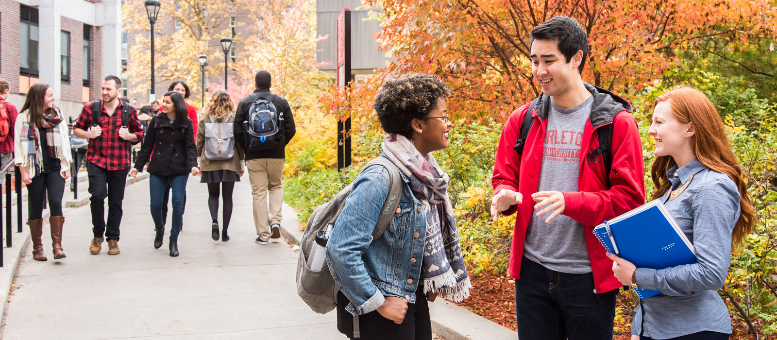 Carleton University students chatting and walking