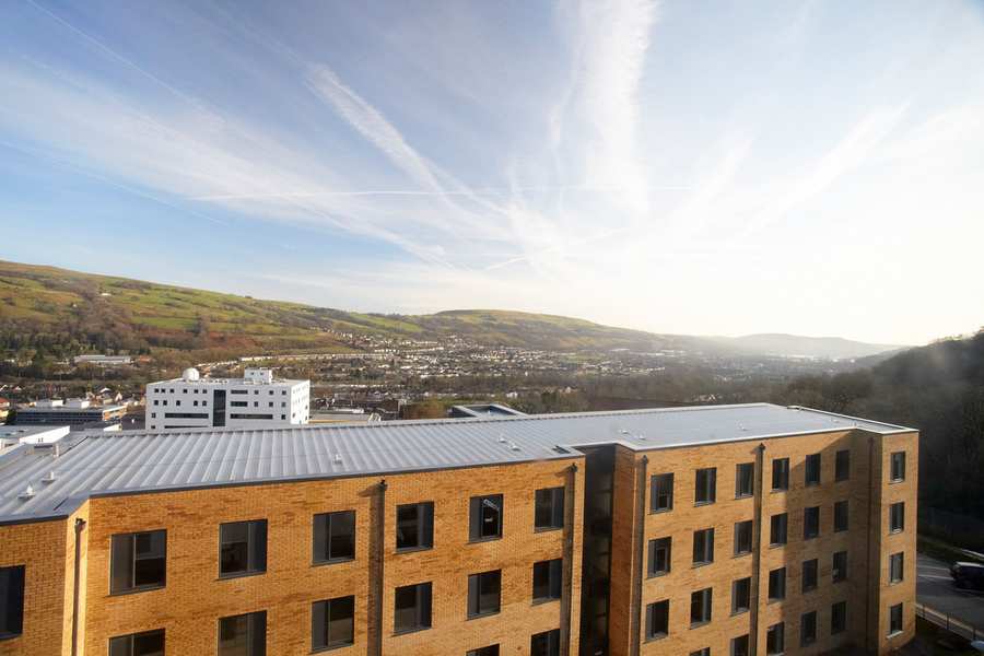 Photograph of sky and hills beyond halls of residence at University of South Wales Treforest campus