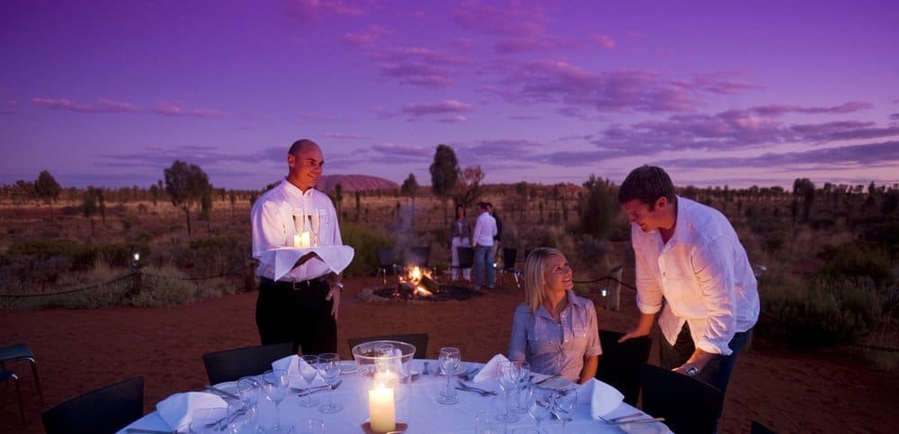 A photo of two servers serving a table.