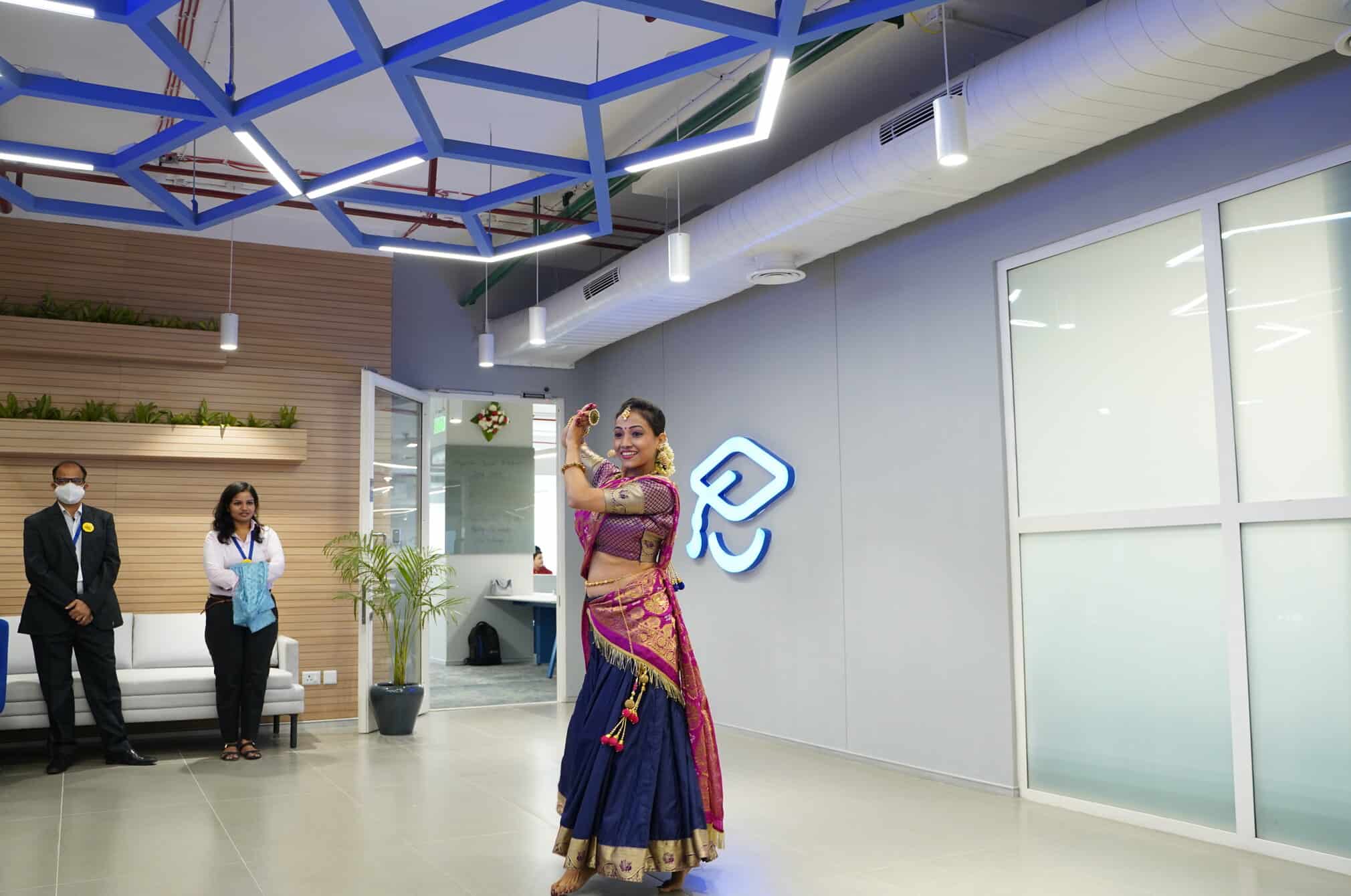 A woman dancing in the new India office.