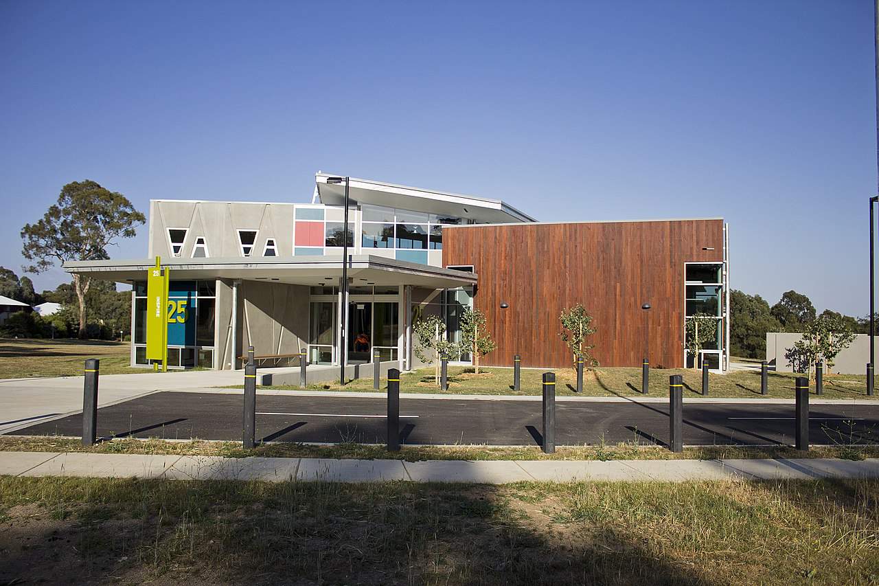 A modern concrete and wood university building.