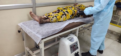 A photo of a woman laying on a hospital bed.