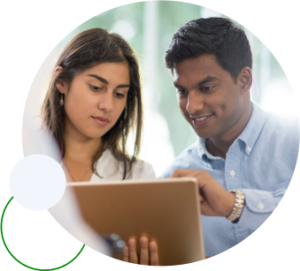 A man and a woman look at a computer monitor; the man's hand is up as if he's showing her something on the screen.