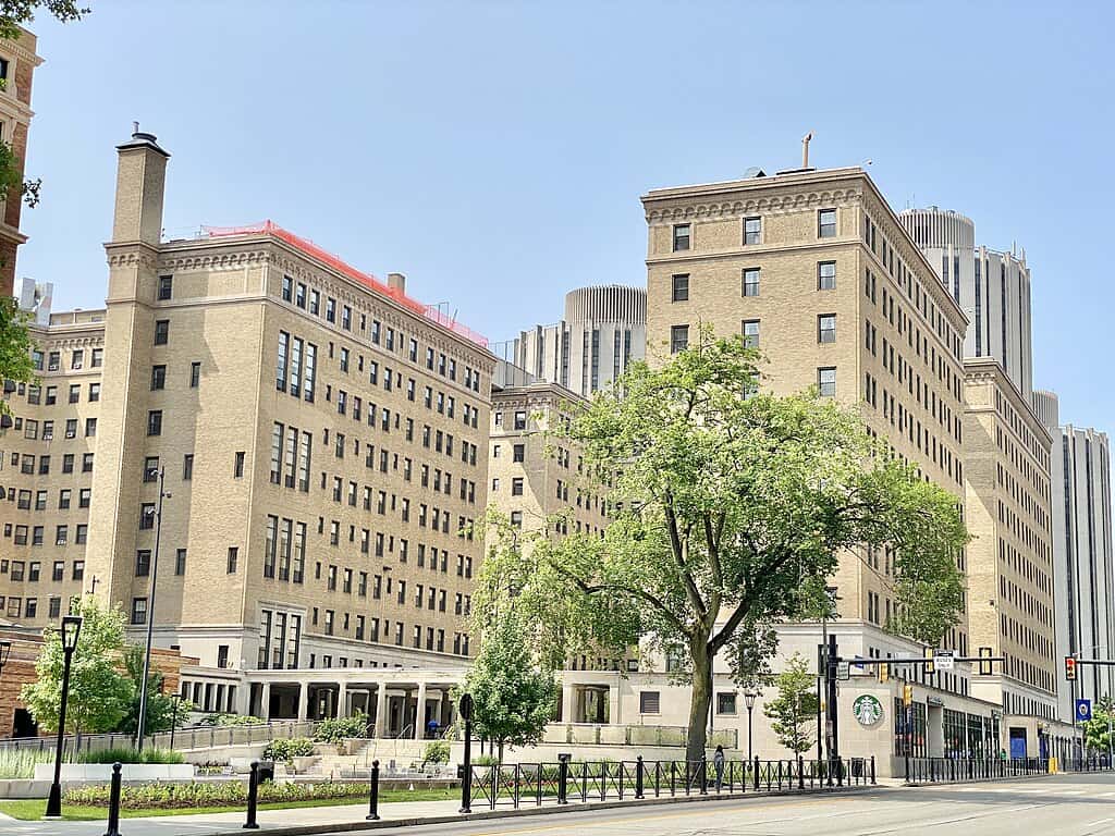 Multistorey university buildings on a city street in Pittsburgh on a sunny day.