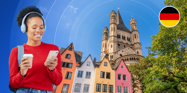 A smiling young woman looks down at her phone while holding a white to-go coffee mug. She is framed by a photographic background with colourful multistorey houses, a warm-hued stone castle, and a German flag logo.