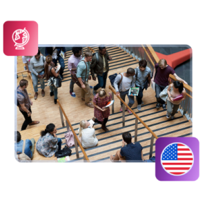 Students climb up and down a wide set of stairs with railings, with illustrations of a globe and the US flag