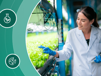 A young female scientist tends to sprouting plants in a greenhouse.