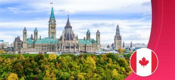 Canada's Parliament government buildings in Ottawa, Ontario, as viewed from the river (somewhat Gothic stone spires with green copper roofs.)