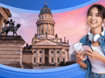 A young woman wearing headphones and a backpack, and carrying a phone and a disposable coffee cup is framed by the German flag and two impressive stone buildings with ornate sculptures at twilight.