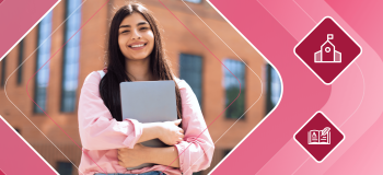 Smiling international student stands in front of a building holding a laptop