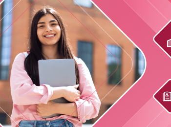 Smiling international student stands in front of a building holding a laptop